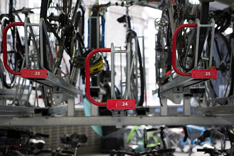 Red handles on Cyclehoop's Optima Two Tier Rack with ID numbers for accessibility when storing bike