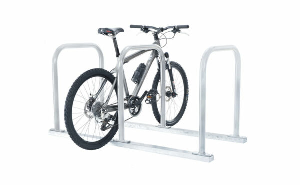 Silver toast rack with parking for three bikes, one space is occupied by a parked black bike